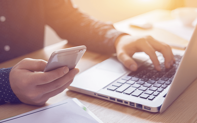 Man using wireless phone and computer