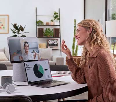 Woman working on wireless desktop computer at office